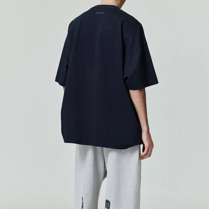 Black Fear of God Essentials Reflective Logo 90s Tee, casual apparel with reflective logo detail, front view showing design details.