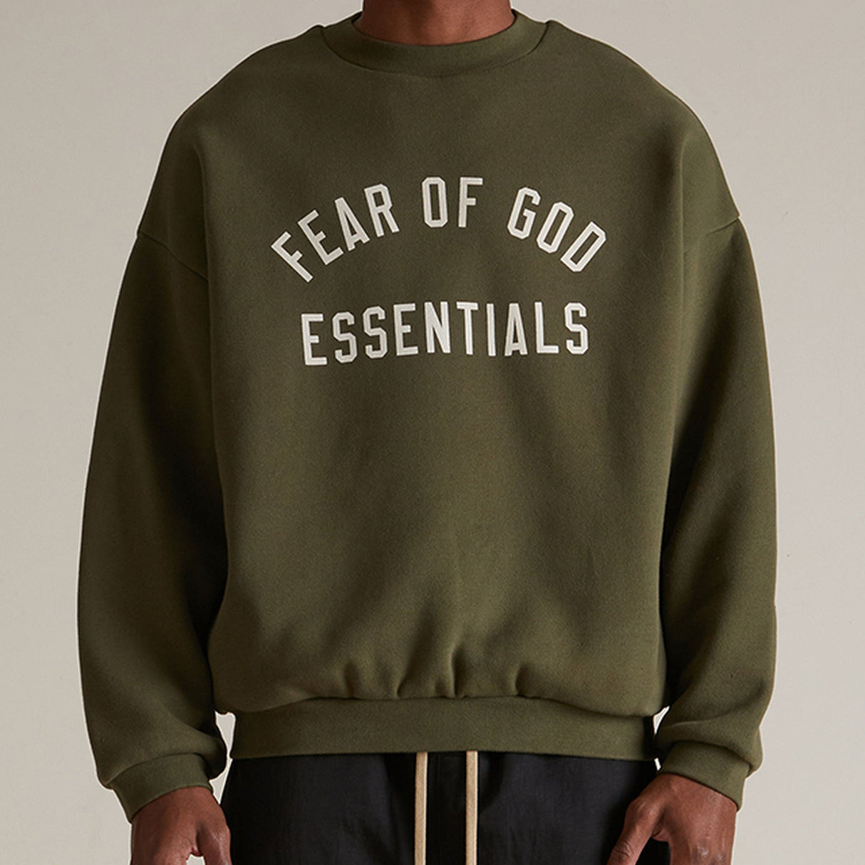 Fear Of God Essentials olive sweatshirt, casual apparel with a relaxed fit, featuring the brand's logo on the front.