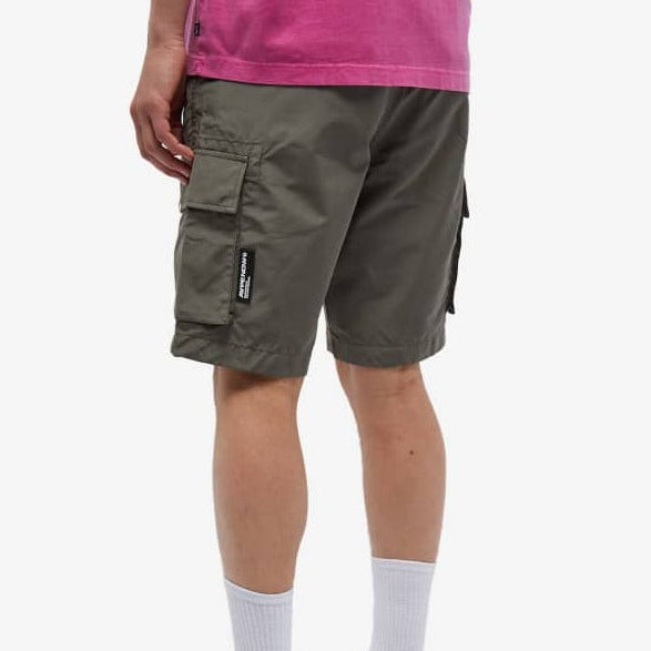 Olive AAPE By Bathing Ape badge cargo shorts with multiple pockets and BAPE logo details, casual streetwear style.