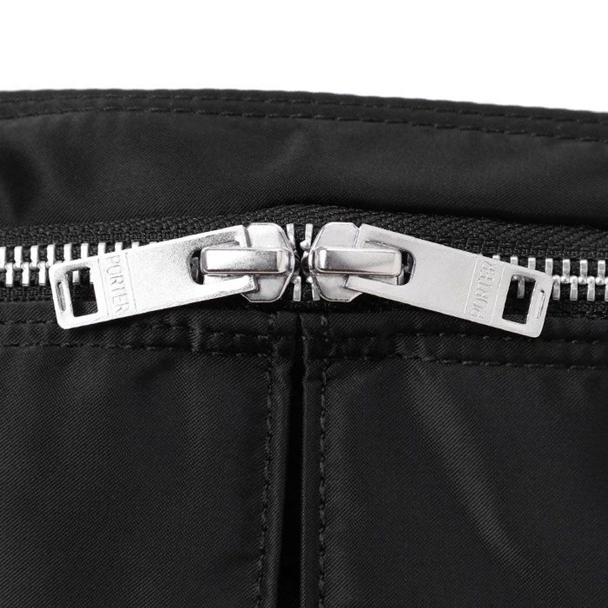 Black Porter Yoshida Japan waist bag with multiple compartments and adjustable strap, designed for practical everyday use.