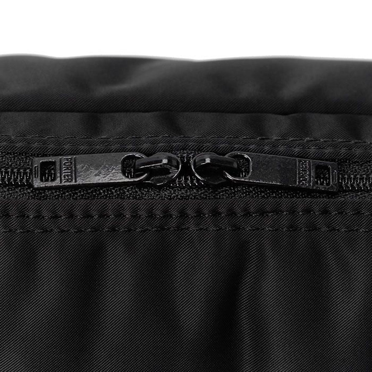 Black Porter Yoshida Japan waist bag with multiple pockets and adjustable strap, made of durable fabric for everyday use.
