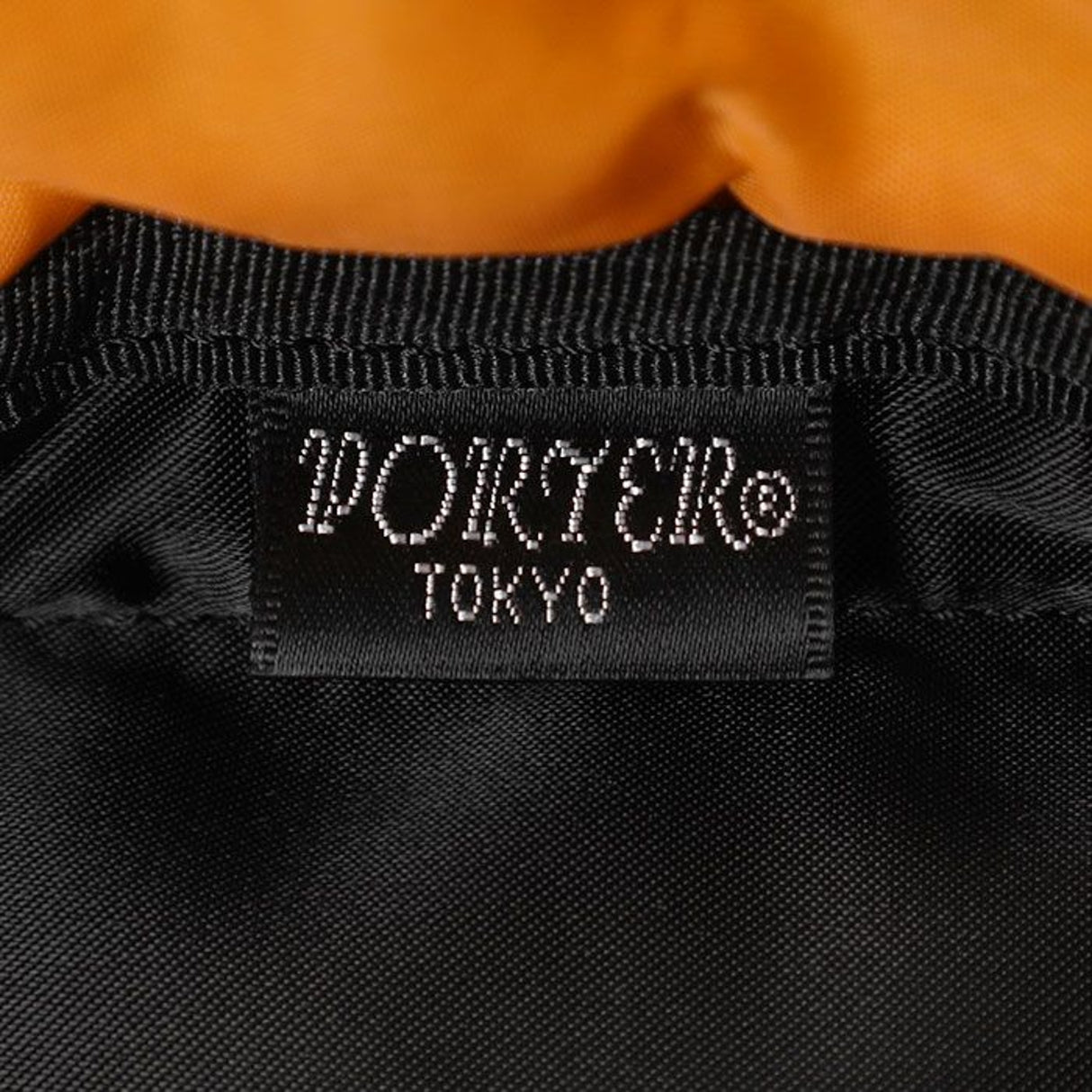 Black Porter Yoshida Japan waist bag with adjustable strap and multiple compartments, crafted from durable fabric.