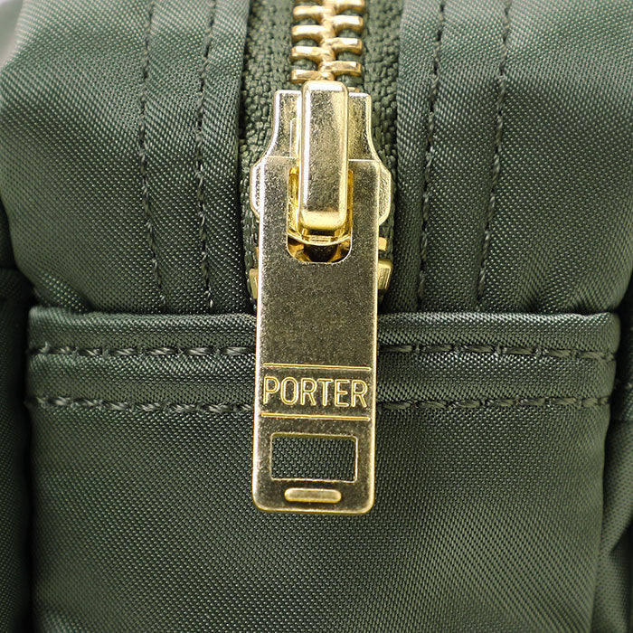 Porter Yoshida Japan Tanker waist bag in sage green, durable fabric with adjustable strap and multiple compartments.
