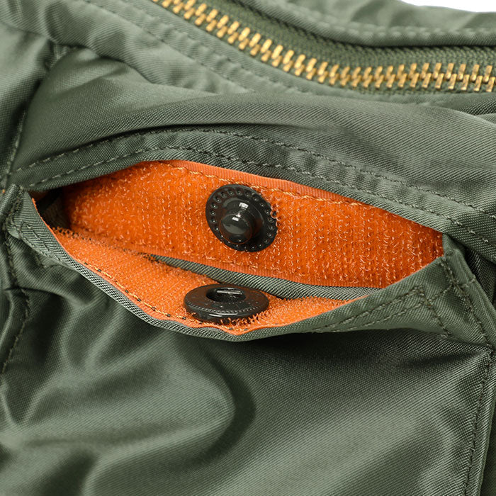 Porter Yoshida Japan Tanker Waist Bag in sage green, made of durable fabric with adjustable strap and multiple compartments.