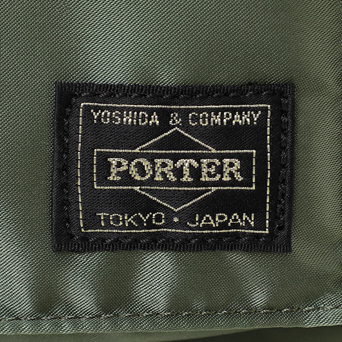 Porter Yoshida Japan Tanker waist bag in sage green, compact and functional with adjustable strap and multiple compartments.