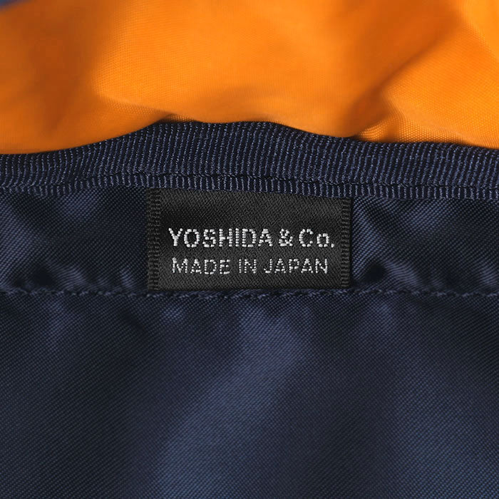 Porter Yoshida Japan waist bag in iron blue with adjustable strap, compact design, and front zipper pocket for storage.