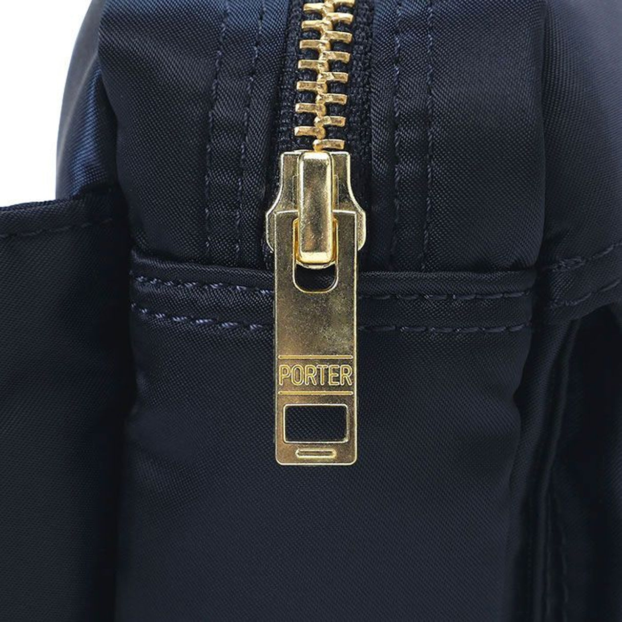 Porter Yoshida Japan Tanker Waist Bag in Iron Blue, stylish and functional bag with adjustable strap and multiple compartments.