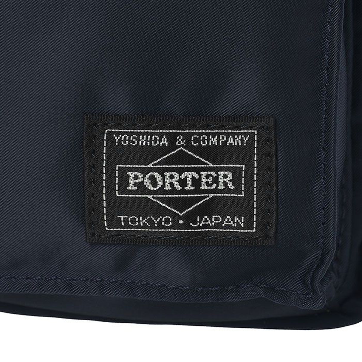 Porter Yoshida Japan Tanker Waist Bag in Iron Blue, compact bag with adjustable strap and multiple compartments.