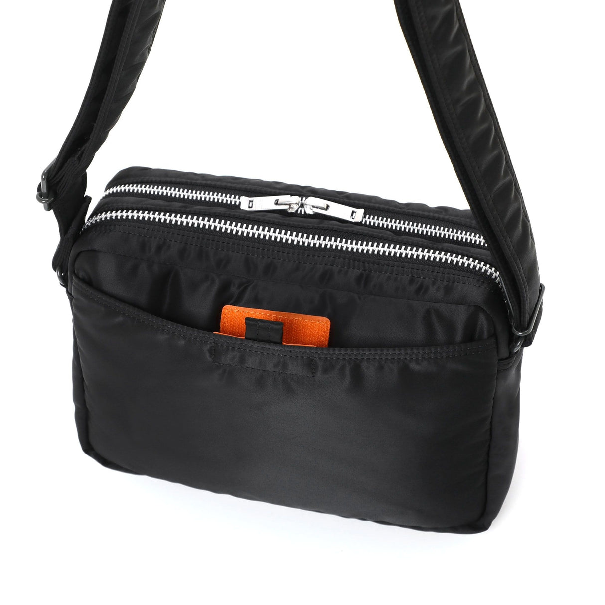 Black Porter Yoshida Japan Tanker Zip Sling Bag with multiple compartments and adjustable strap, stylish and functional design.
