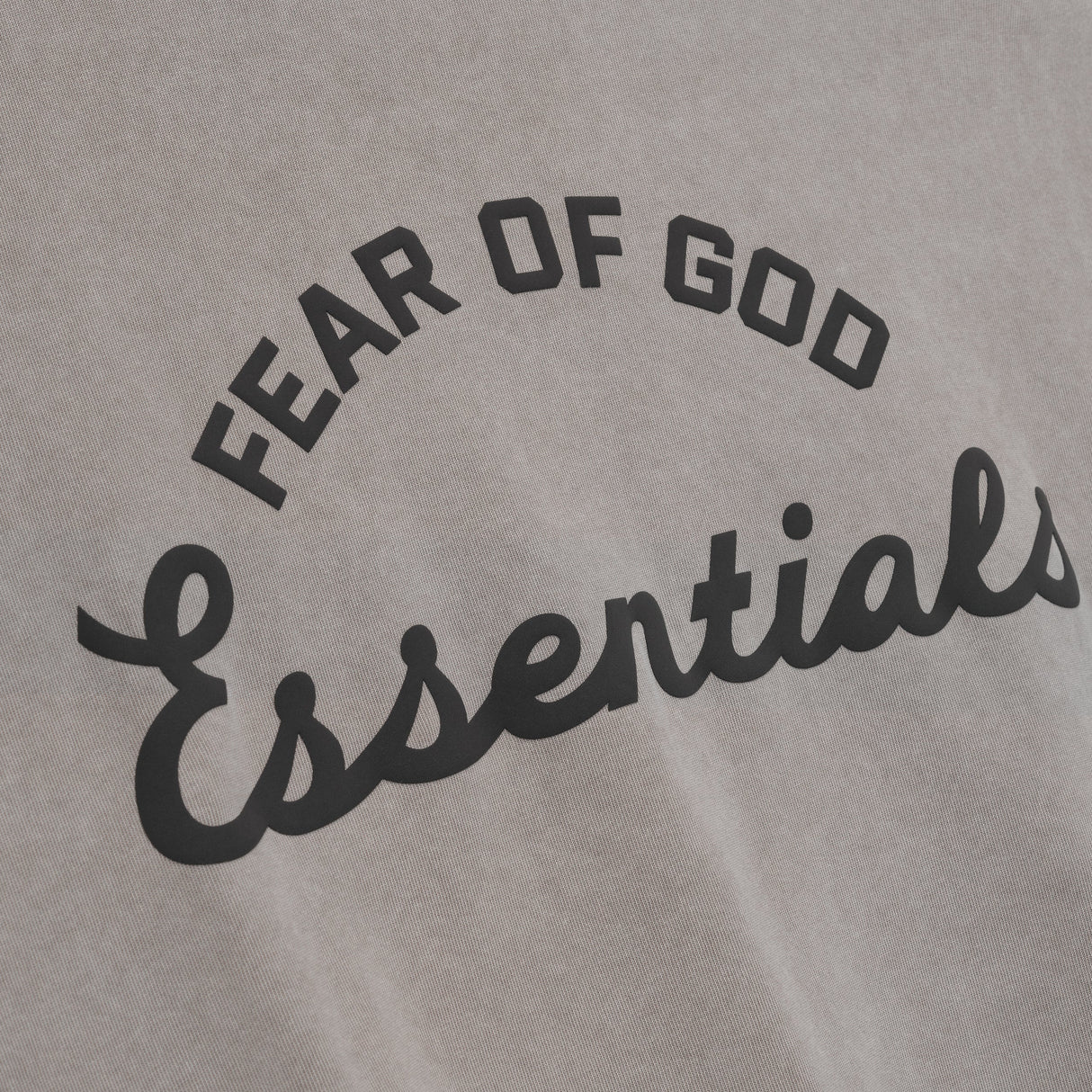 Fear of God Essentials Training 90s heavyweight short sleeve tee in faded dune color, displayed on a flat lay with a minimalist background.