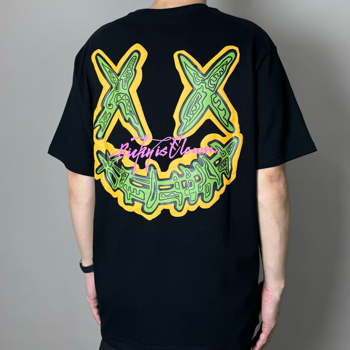 RICKYISCLOWN embossed pop art black T-shirt with bold graphic design, short sleeves, and crew neckline, casual apparel for street style.