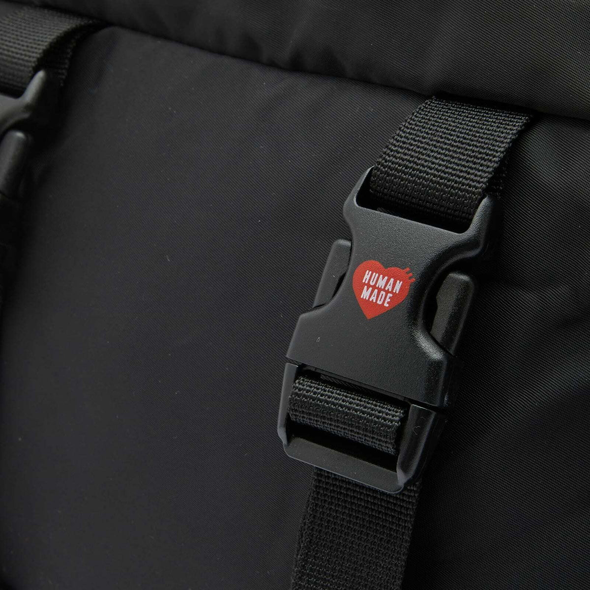 Black Human Made military backpack with multiple compartments and adjustable straps, designed for durability and style.