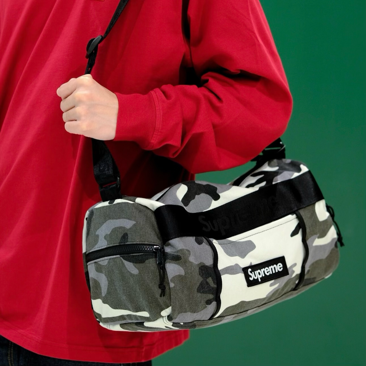 Supreme utility sling bag in snow camo pattern, featuring adjustable strap and multiple compartments for everyday use.