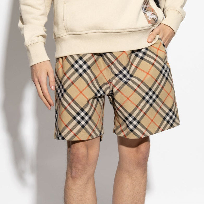 Burberry Diagonal Check shorts in beige and black fabric, featuring the signature check pattern and tailored fit.