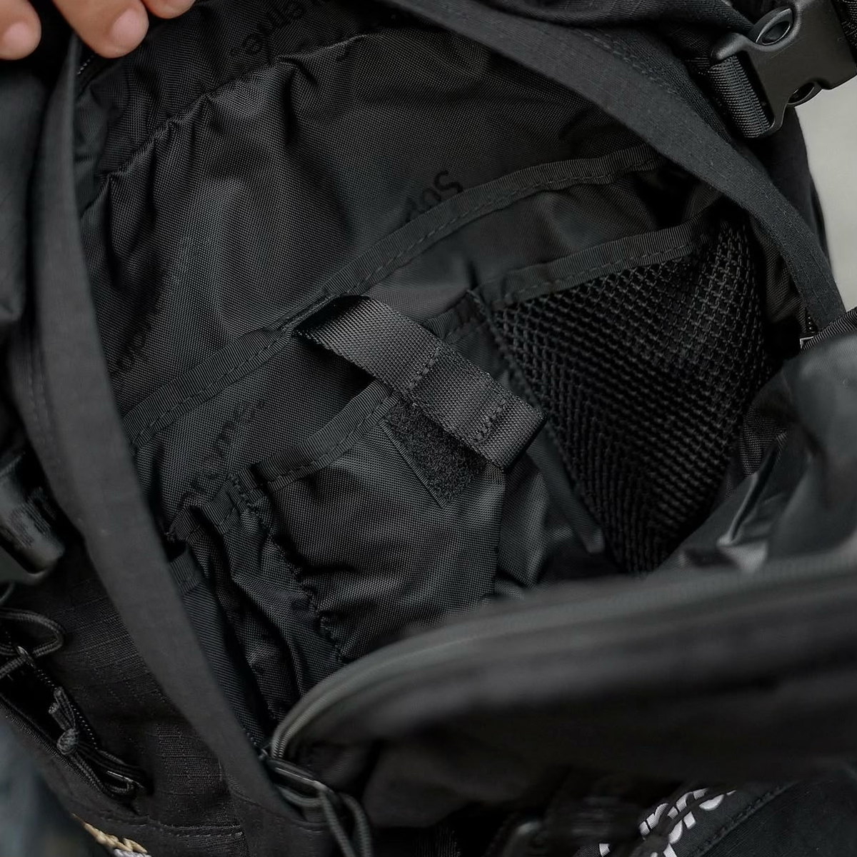 Black Supreme Box Logo backpack with adjustable straps and front logo patch, designed for stylish everyday use.