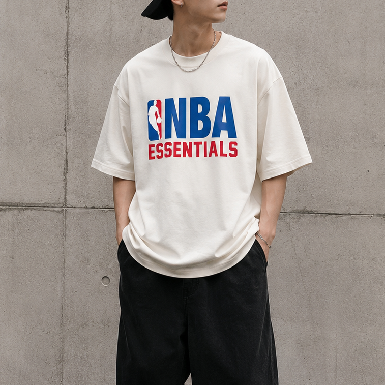 Cream Fear of God Essentials NBA 90s Heavyweight Tee, casual men's apparel with bold graphic design and comfortable fit.