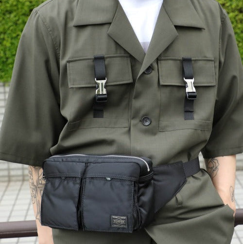 Black Porter Yoshida Japan Tanker Waist Bag with adjustable strap and multiple compartments, made of durable fabric.