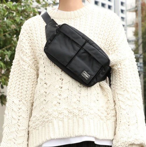 Black Porter Yoshida Japan Tanker Waist Bag with adjustable strap and multiple compartments, designed for casual and outdoor use.