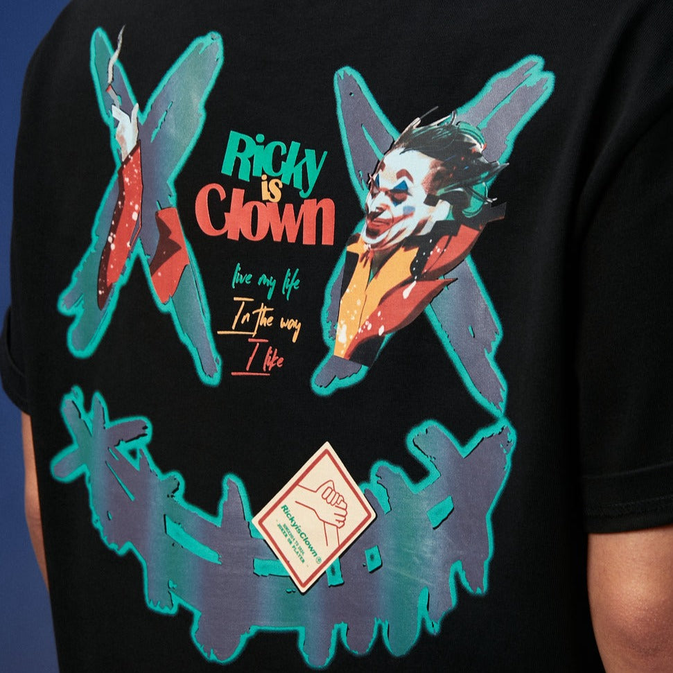 Black Rickyisclown Joker Laser Reflective Smiley Tee featuring a bold graphic design, casual apparel by RICKYISCLOWN.