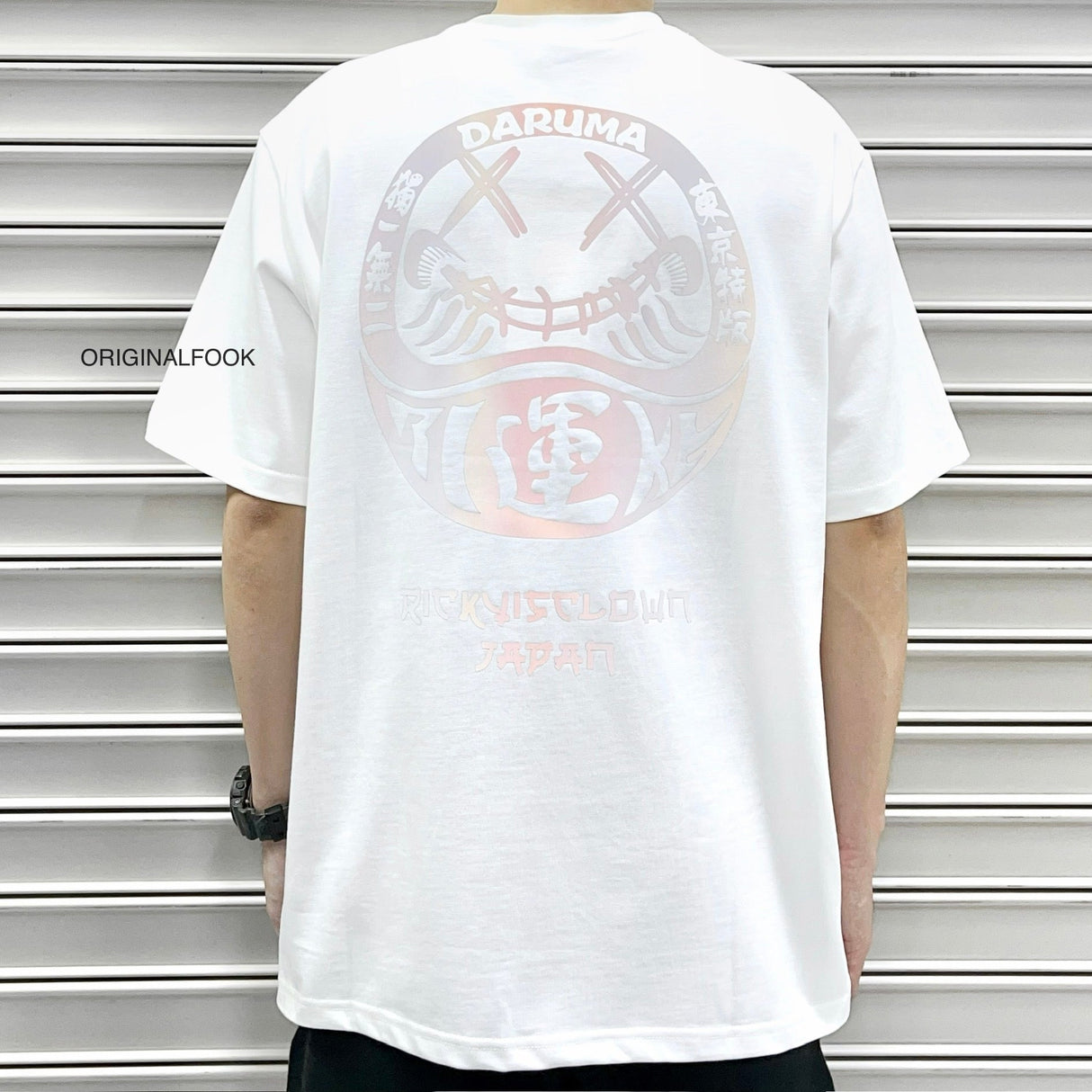 White Rickyisclown Japan Lucky Daruma laser reflective T-shirt featuring bold Daruma design and RICKYISCLOWN branding.