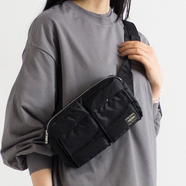 Porter Yoshida Japan Tanker Waist Bag in black, casual and durable design with adjustable strap and multiple compartments.