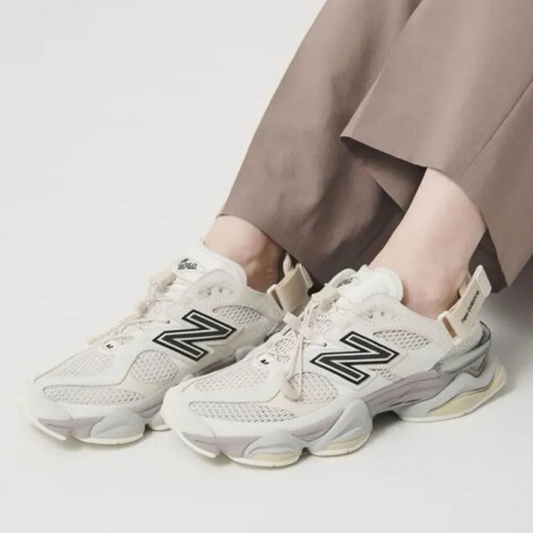 New Balance 9060 Mule sneakers in off-white and mauve with a sleek, modern design and comfortable fit.