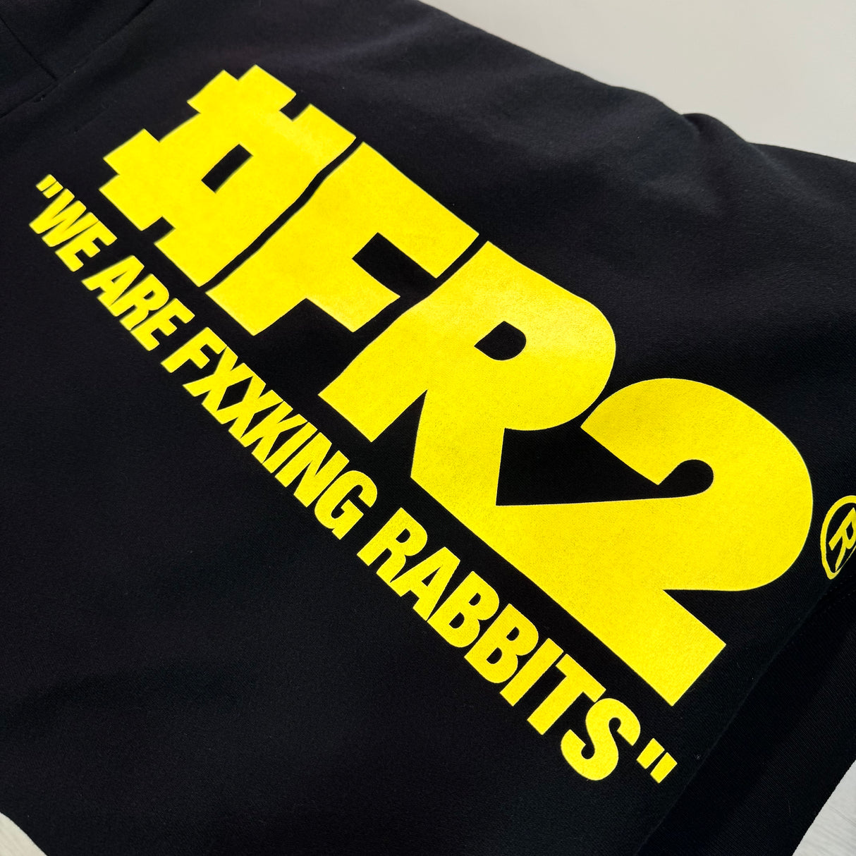 Black FR2 Big Logo Hoodie with prominent branding and comfortable fit, displayed on a hanger in a retail setting.