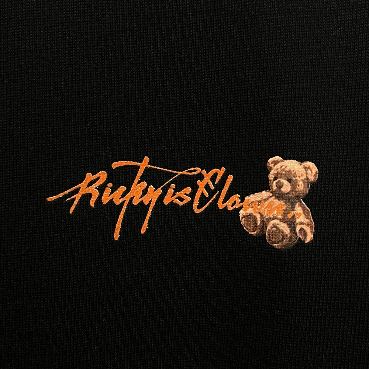 Black Rickyisclown hanging bear smiley T-shirt featuring a playful bear graphic, casual apparel from Rickyisclown.