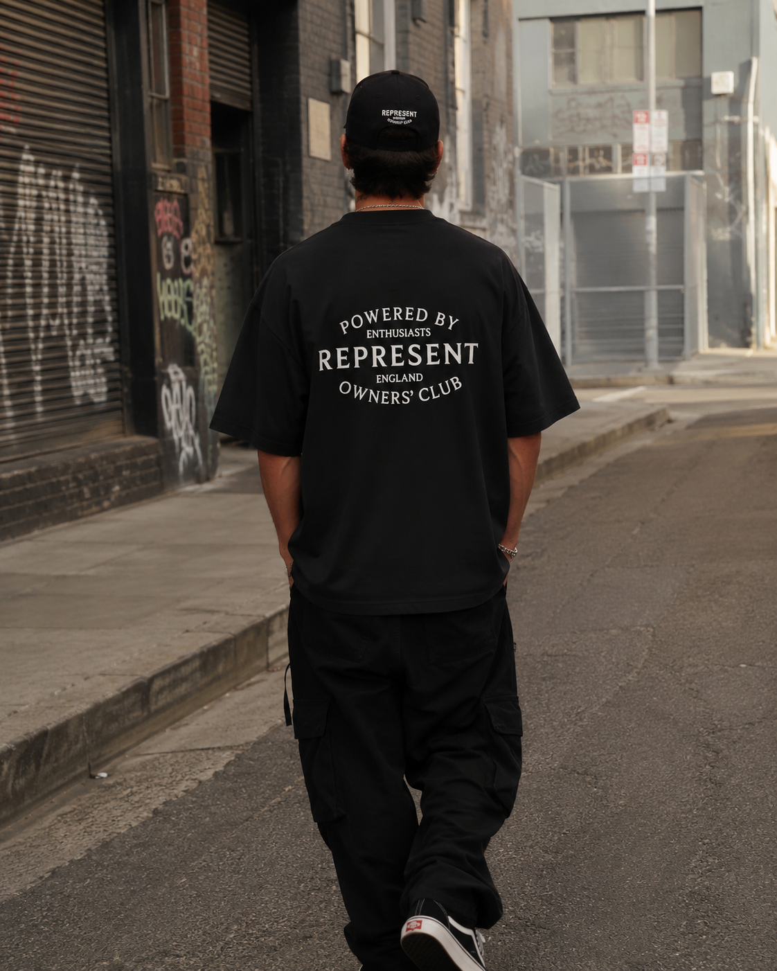 Black Represent Stamp Logo Tee featuring a bold printed logo design on the front, casual men's t-shirt.