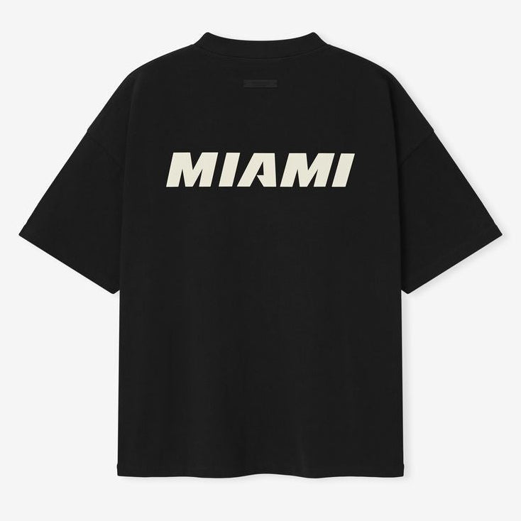 Fear of God Essentials NBA 90s Heavyweight Tee in black, featuring bold graphic design and comfortable heavyweight fabric.