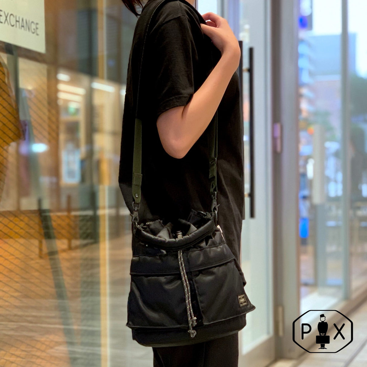 Black Porter Yoshida Japan Tanker 2-Way Tool Bag with multiple compartments and sturdy handles, designed for versatile carrying.