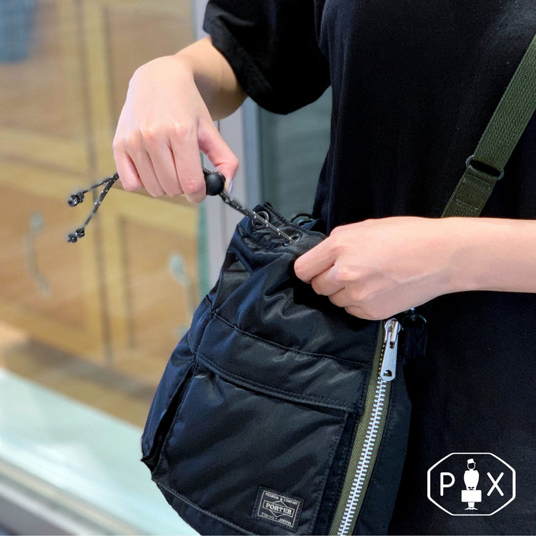 Black Porter Yoshida Japan Tanker 2-Way Tool Bag with multiple compartments and sturdy handle, designed for versatile tool storage.