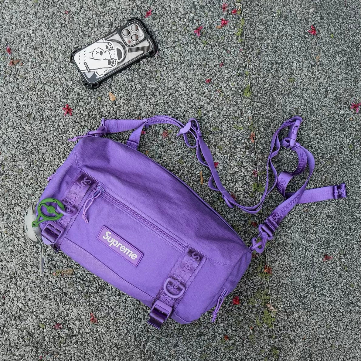 Supreme purple box logo utility bag with adjustable strap and multiple compartments, showcasing its durable fabric and bold design.