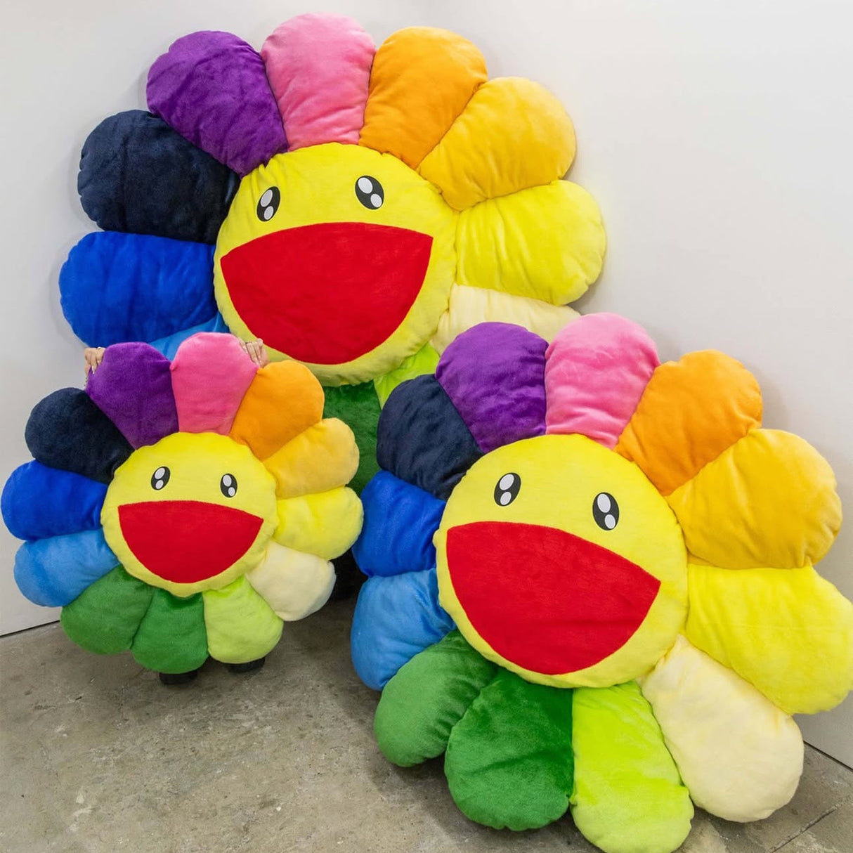 Takashi Murakami Flower plush cushion in vibrant rainbow colors, 1 meter tall, featuring signature floral design and soft fabric.
