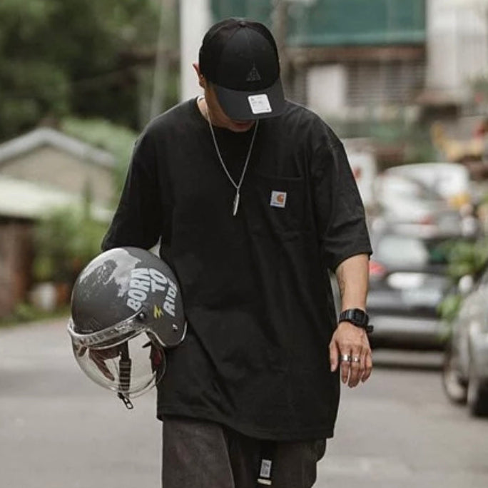 Carhartt K87 oversized black pocket T-shirt, casual apparel with front chest pocket, made from soft cotton fabric.