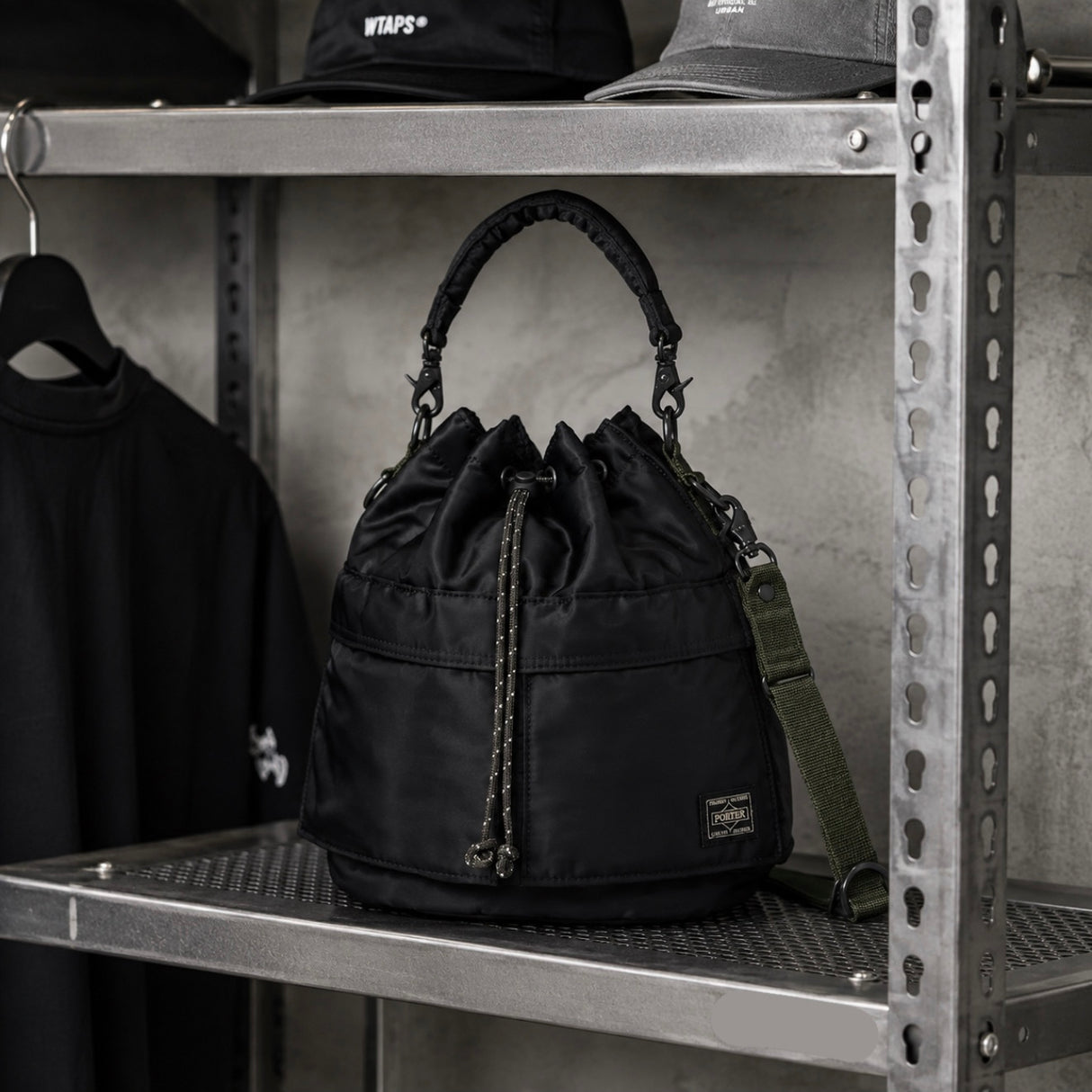 Black Porter Yoshida Japan Tanker 2-Way Tool Bag with multiple compartments and sturdy handles, designed for versatile storage.
