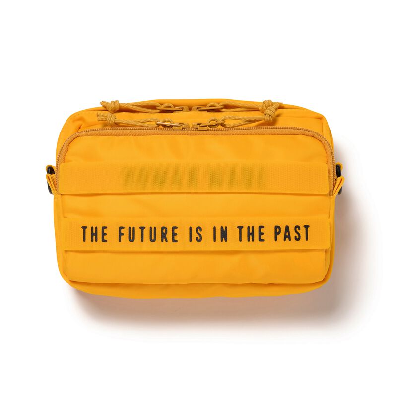 Yellow Human Made military sling bag with adjustable strap, compact design, and multiple compartments for versatile carrying.