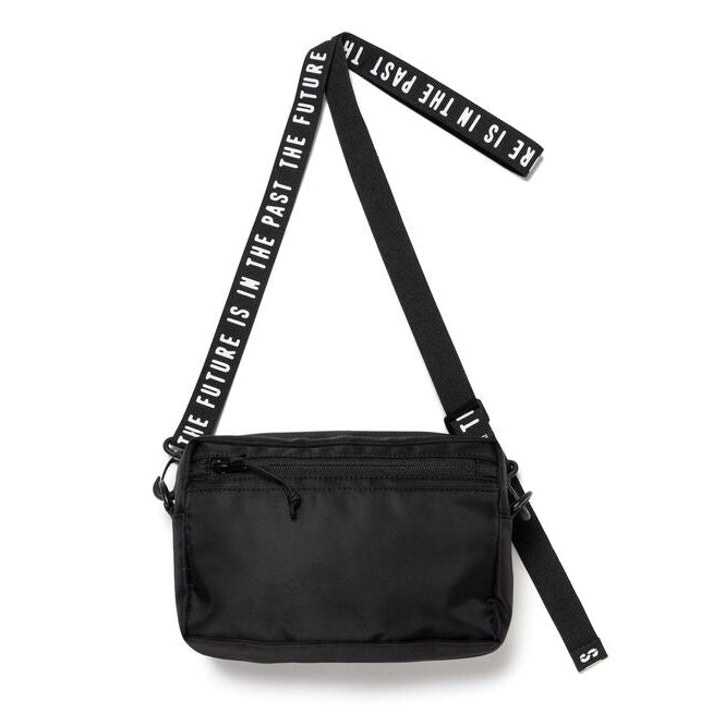 Black Human Made military sling bag with adjustable strap and multiple compartments, designed for casual and outdoor use.