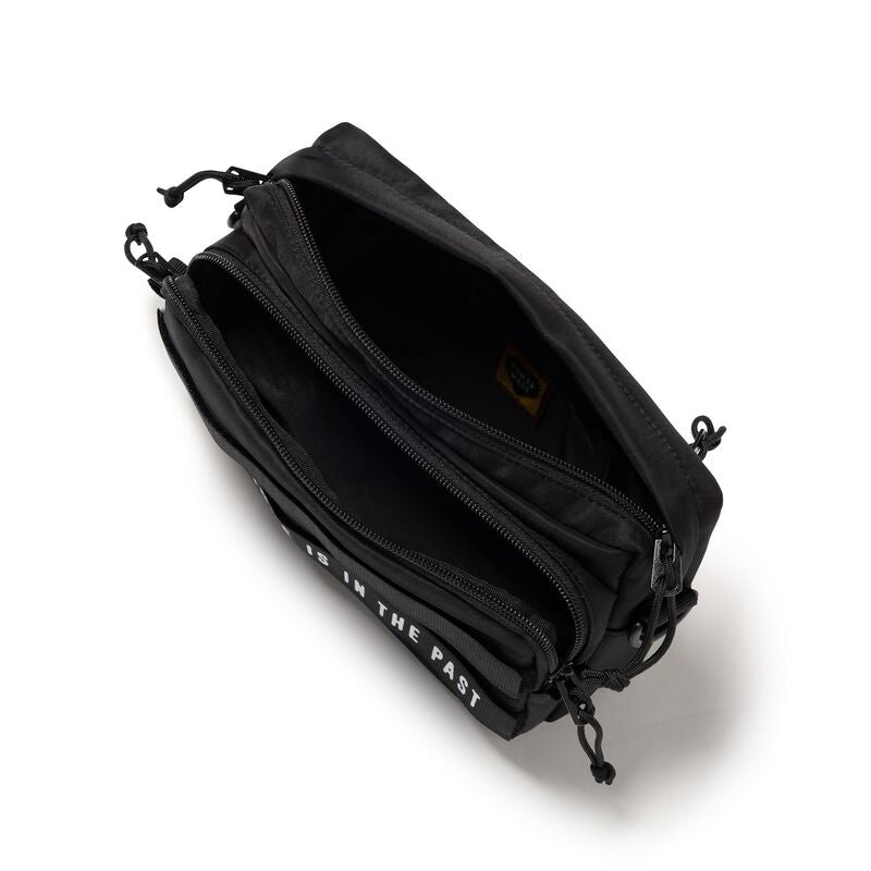 Black Human Made Military Sling Bag with adjustable strap, multiple compartments, and durable fabric for versatile carrying.