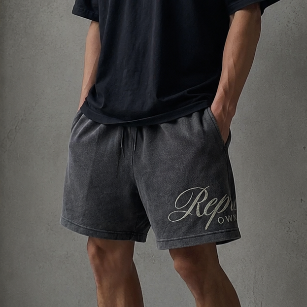 Represent Script Mesh Shorts Vintage Black featuring black mesh fabric and embroidered script logo for a stylish athletic look.