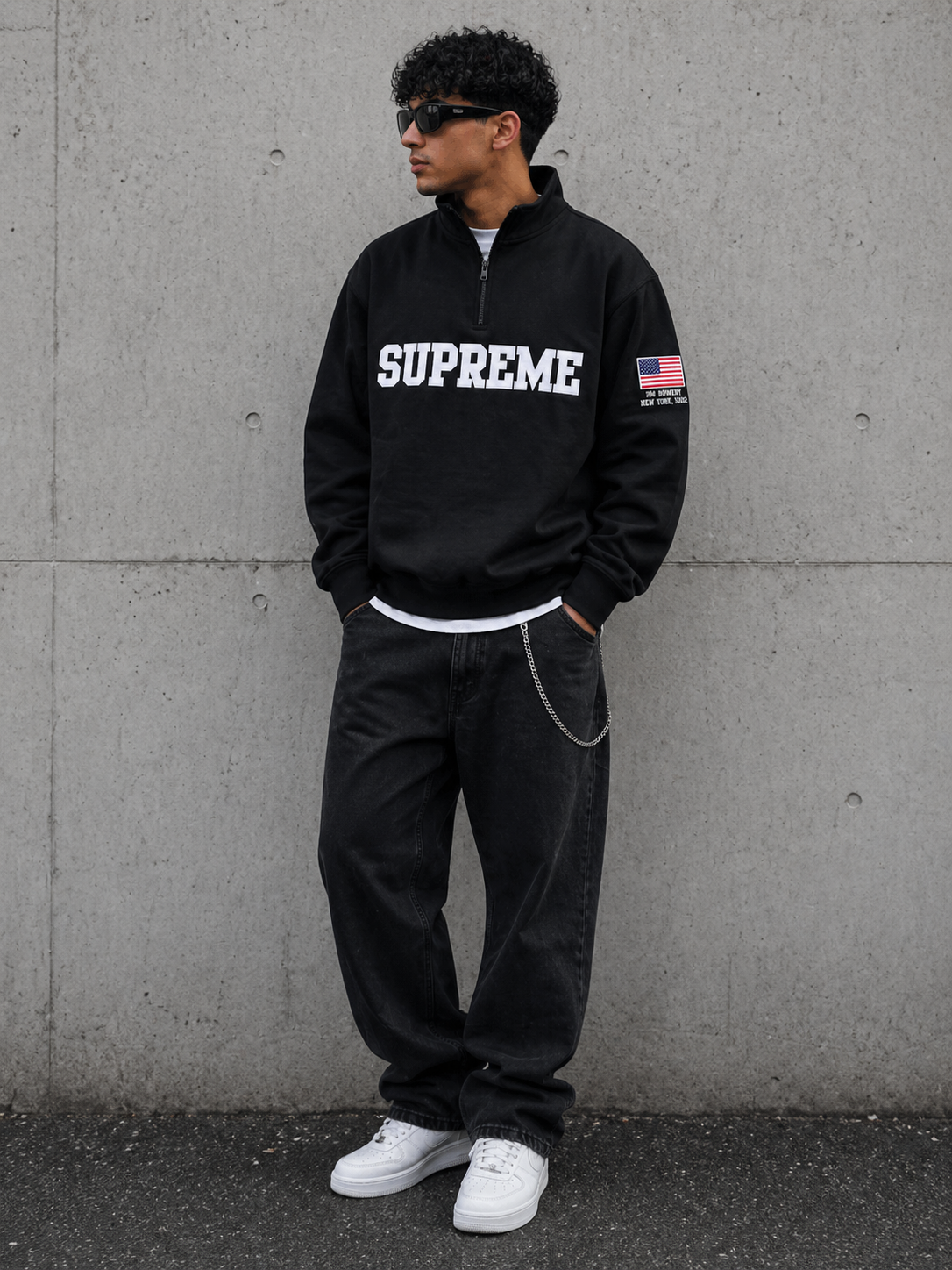 Black Supreme half zip pullover, United States Edition, casual apparel with a sleek design and front zipper detail.