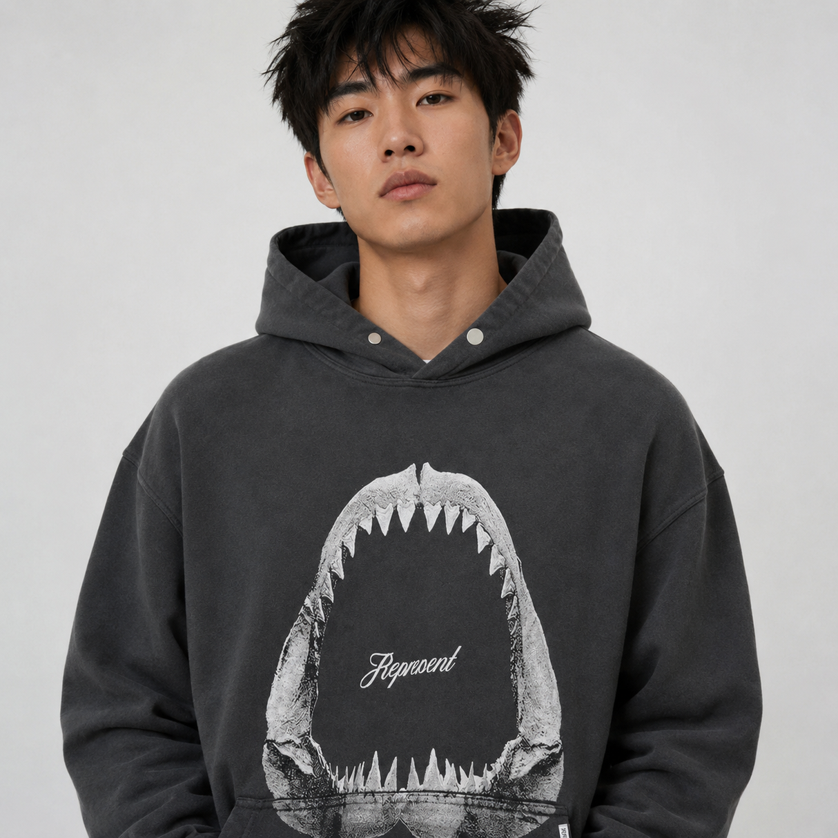 Represent Shark Jaws Hoodie in Off Black, featuring a bold shark graphic design on the front, casual streetwear style.