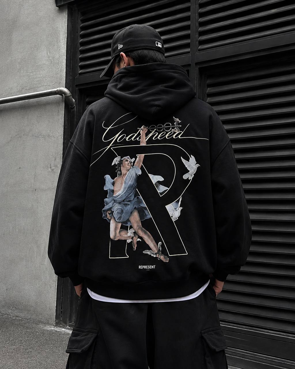 Black Represent Hermes hoodie, a stylish casual apparel item featuring the brand logo on the front, displayed on a hanger.