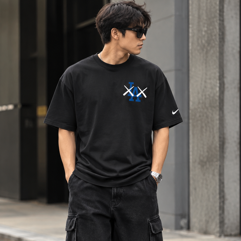Black MLB X KAWS X Nike Los Angeles Dodgers T-shirt featuring graphic design, casual apparel from HUMAN MADE.