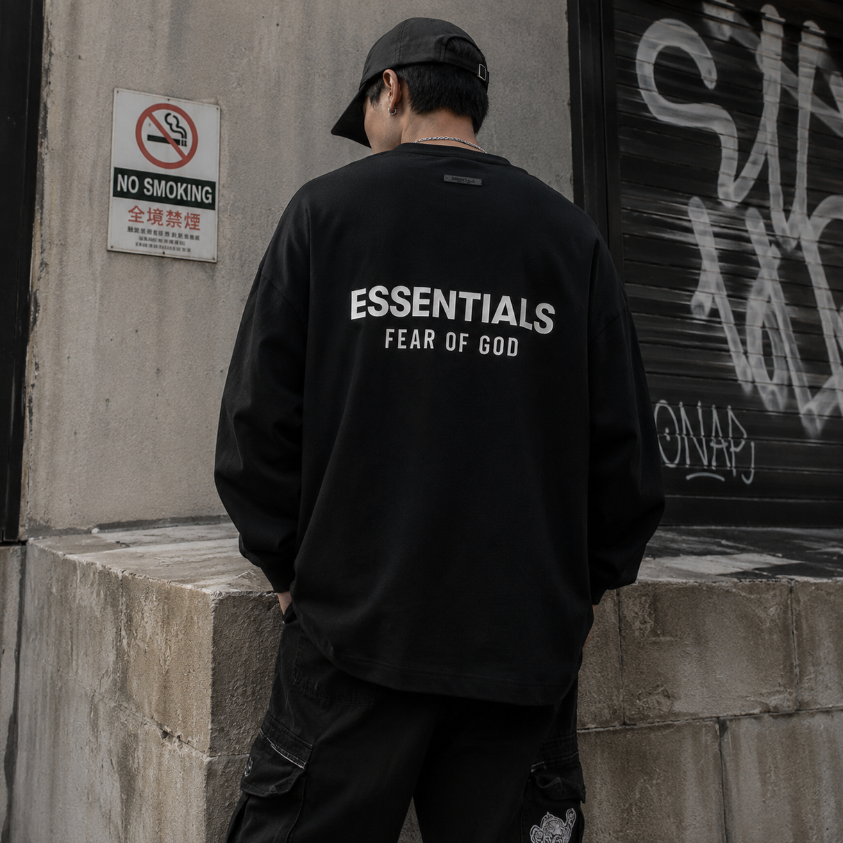 Black Fear of God Essentials Classic Long Sleeve Tee displayed flat, showcasing its simple, stylish design and crew neckline.