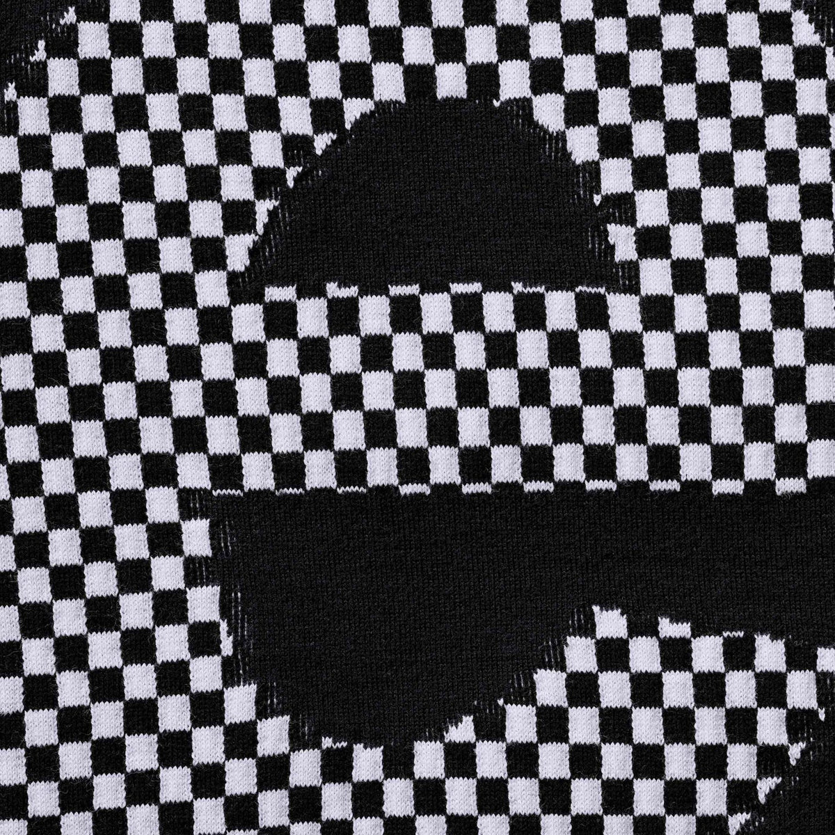 Supreme black checkered intarsia T-shirt featuring bold checkerboard pattern, crew neck, and Supreme branding for stylish casual wear.