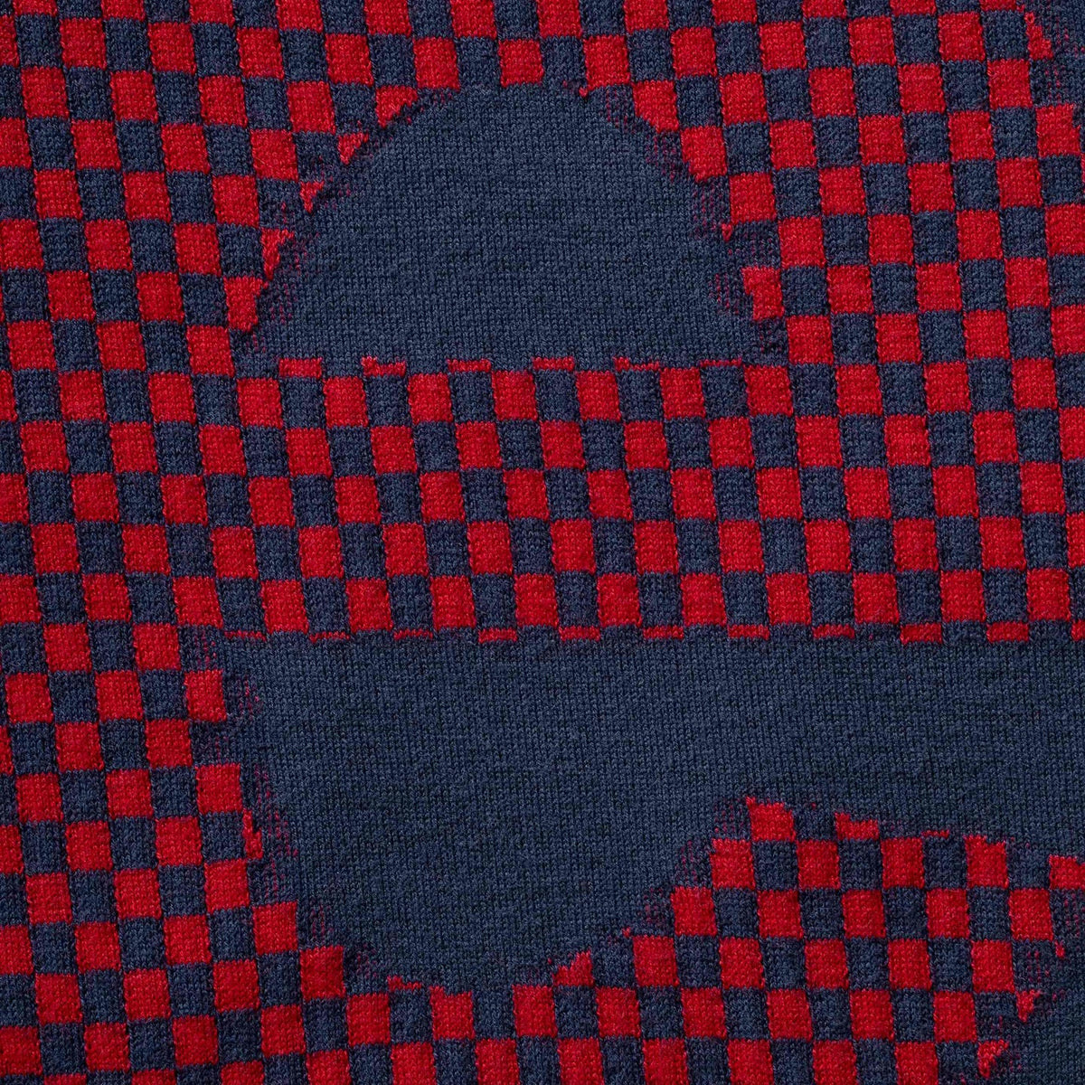 Supreme checkered intarsia navy t-shirt with bold checkerboard pattern, casual crew neck design, and Supreme branding.