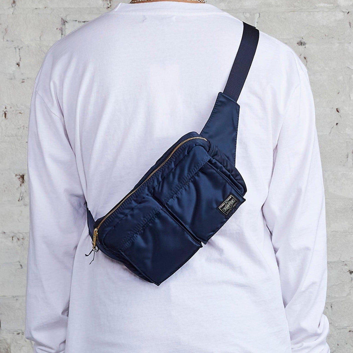 Porter Yoshida Japan Tanker waist bag in iron blue with adjustable strap and multiple compartments, casual and functional design.