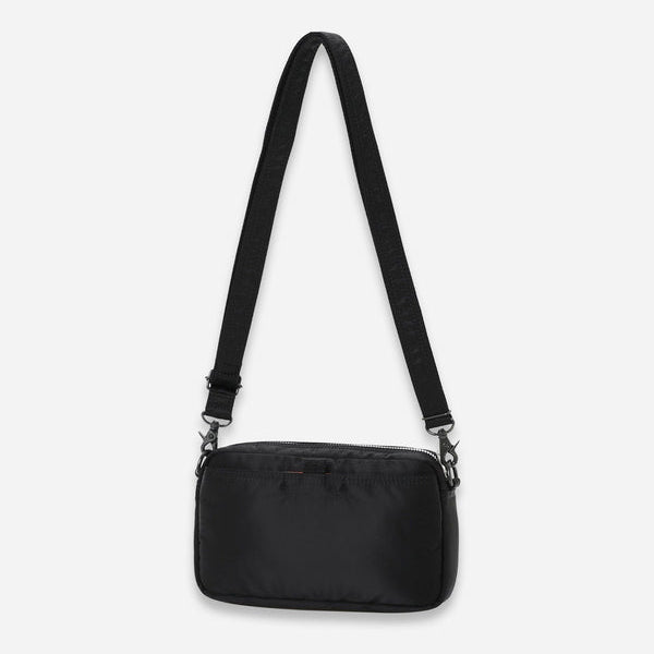 Black Porter Yoshida Japan Tanker Sling Bag with adjustable strap and compact design, featuring durable material and sleek style.