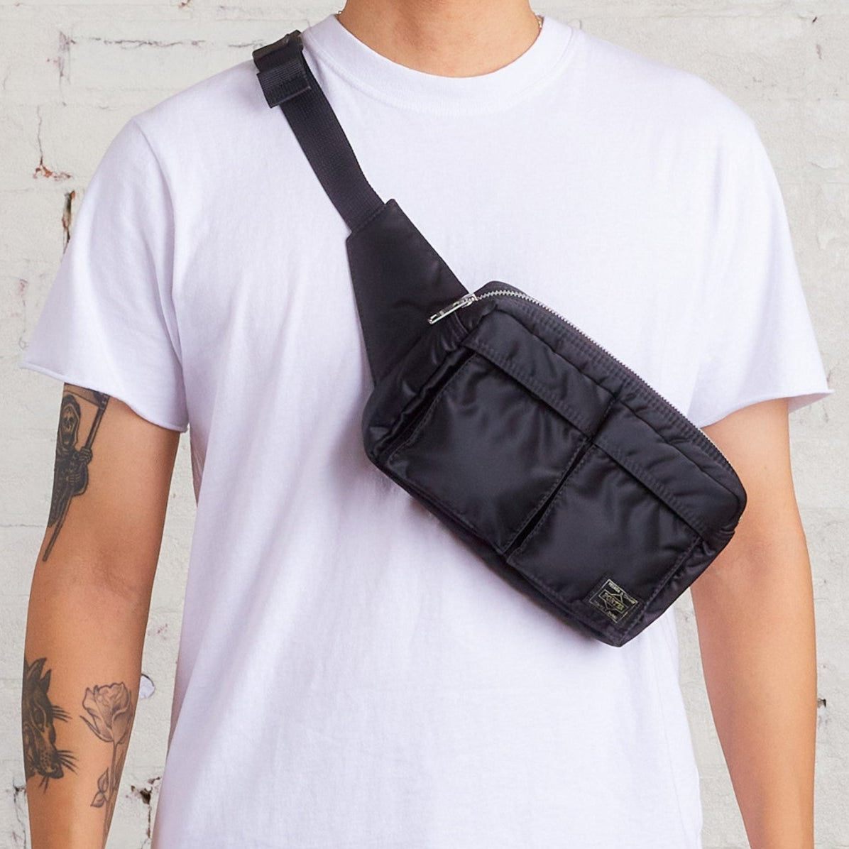Black Porter Yoshida Japan Tanker Waist Bag with adjustable strap and multiple compartments, designed for everyday use.